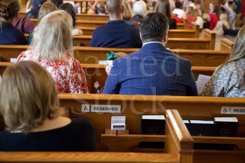 Dad holding baby in pew